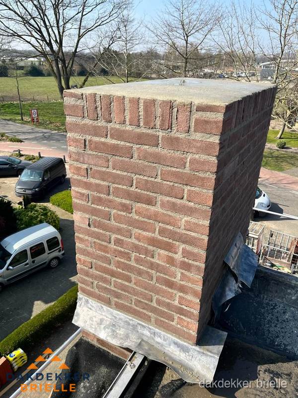 Gemetselde schoorsteen met loodaansluiting op dak in Brielle Gemetselde schoorsteen met loodaansluiting op dak in Brielle