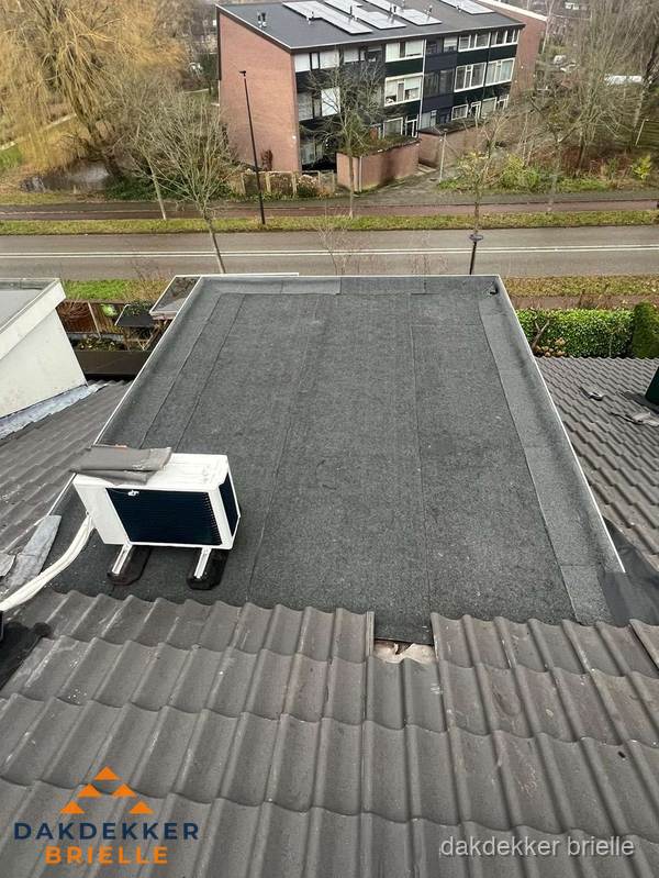 Plat dak inspectie met bitumen bedekking naast schuin pannendak in Brielle Plat dak inspectie met bitumen bedekking naast schuin pannendak in Brielle